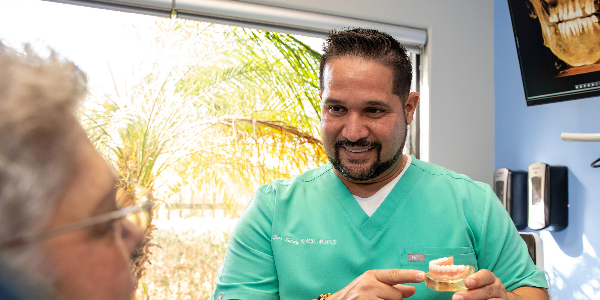 doctor going over dental procedure information with patient