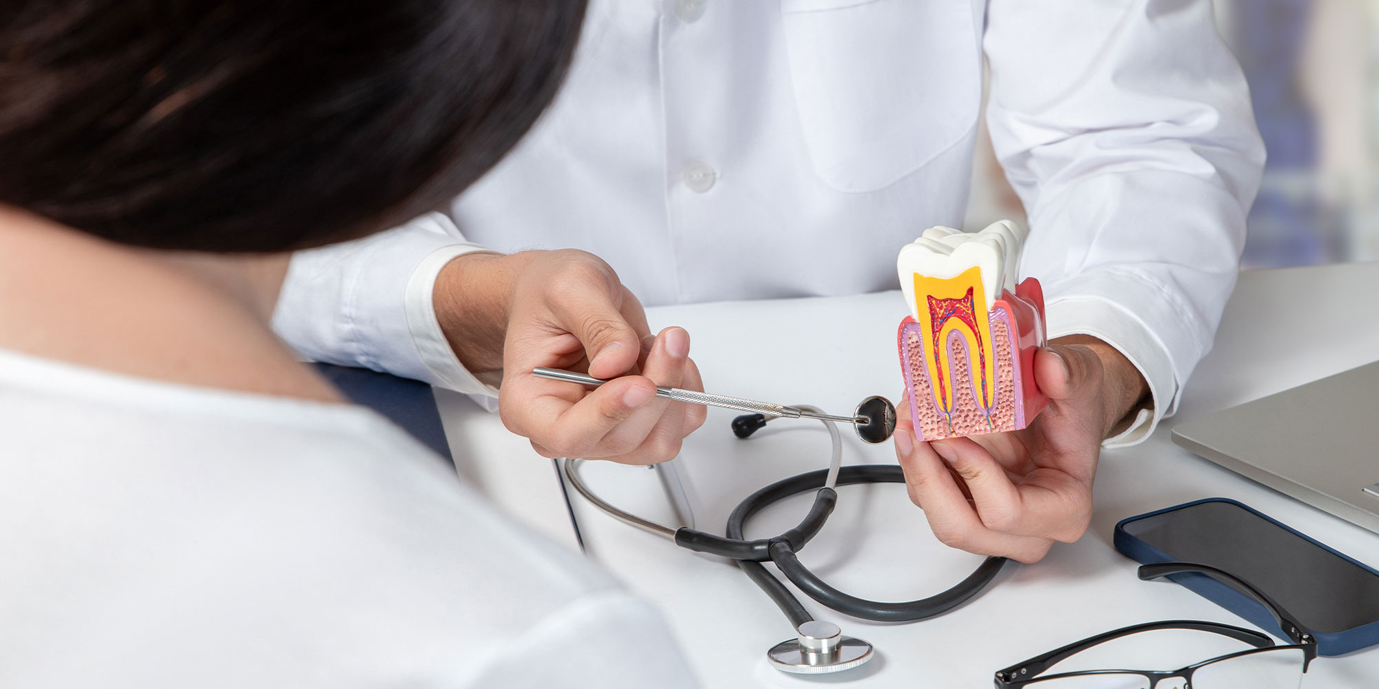 Doctor consulting a female patient about dental diseases