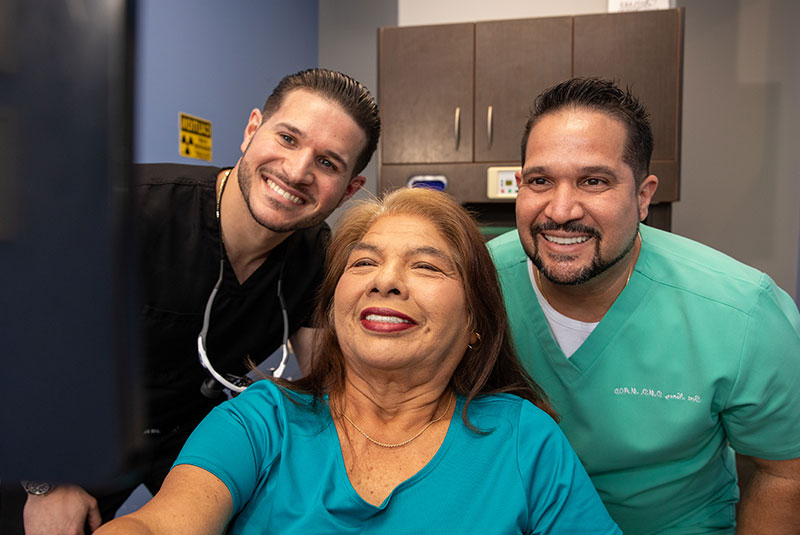 patient and doctor both smiling together after dental procedure