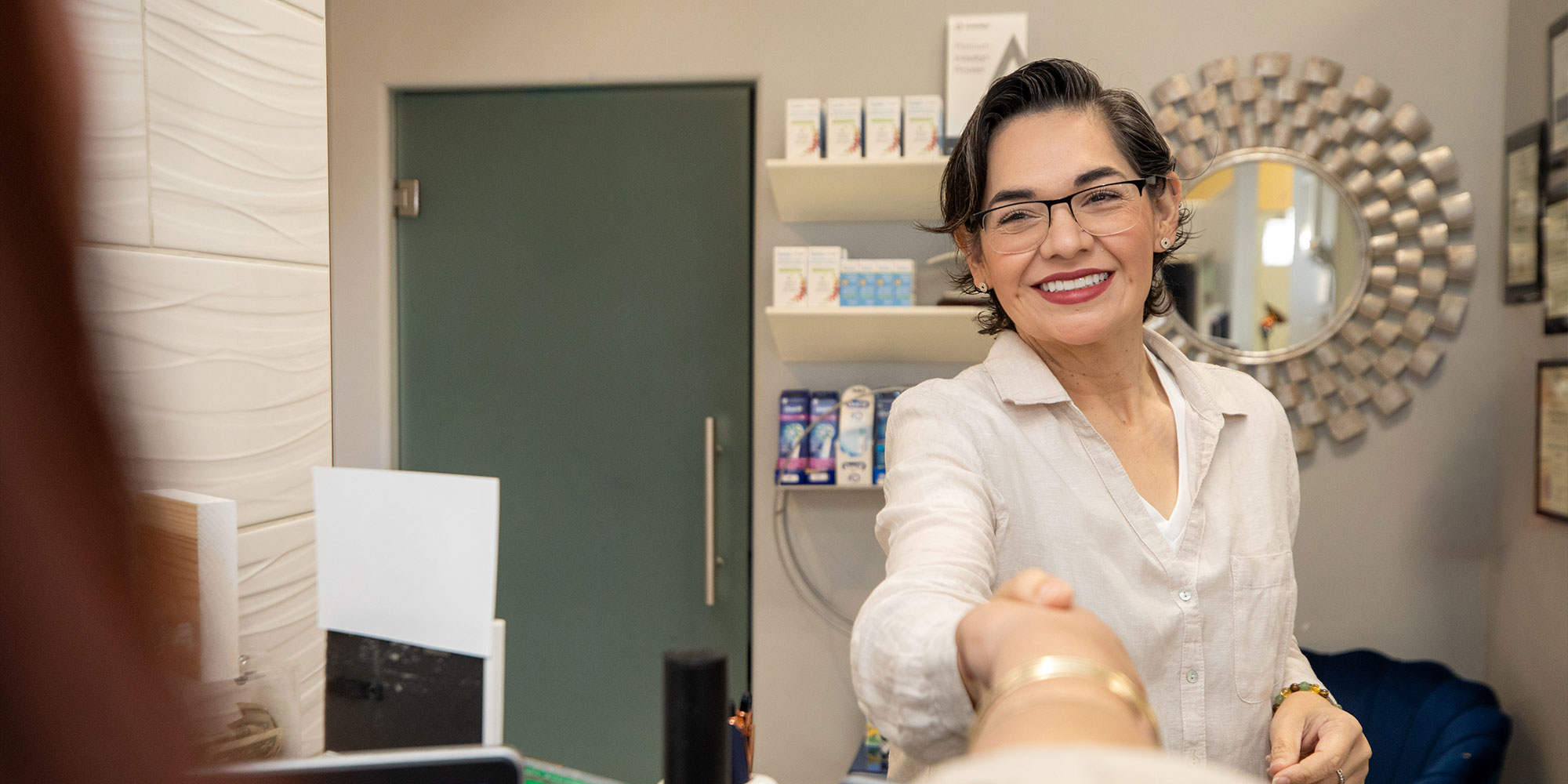 patient being helped at the front desk of the dental center