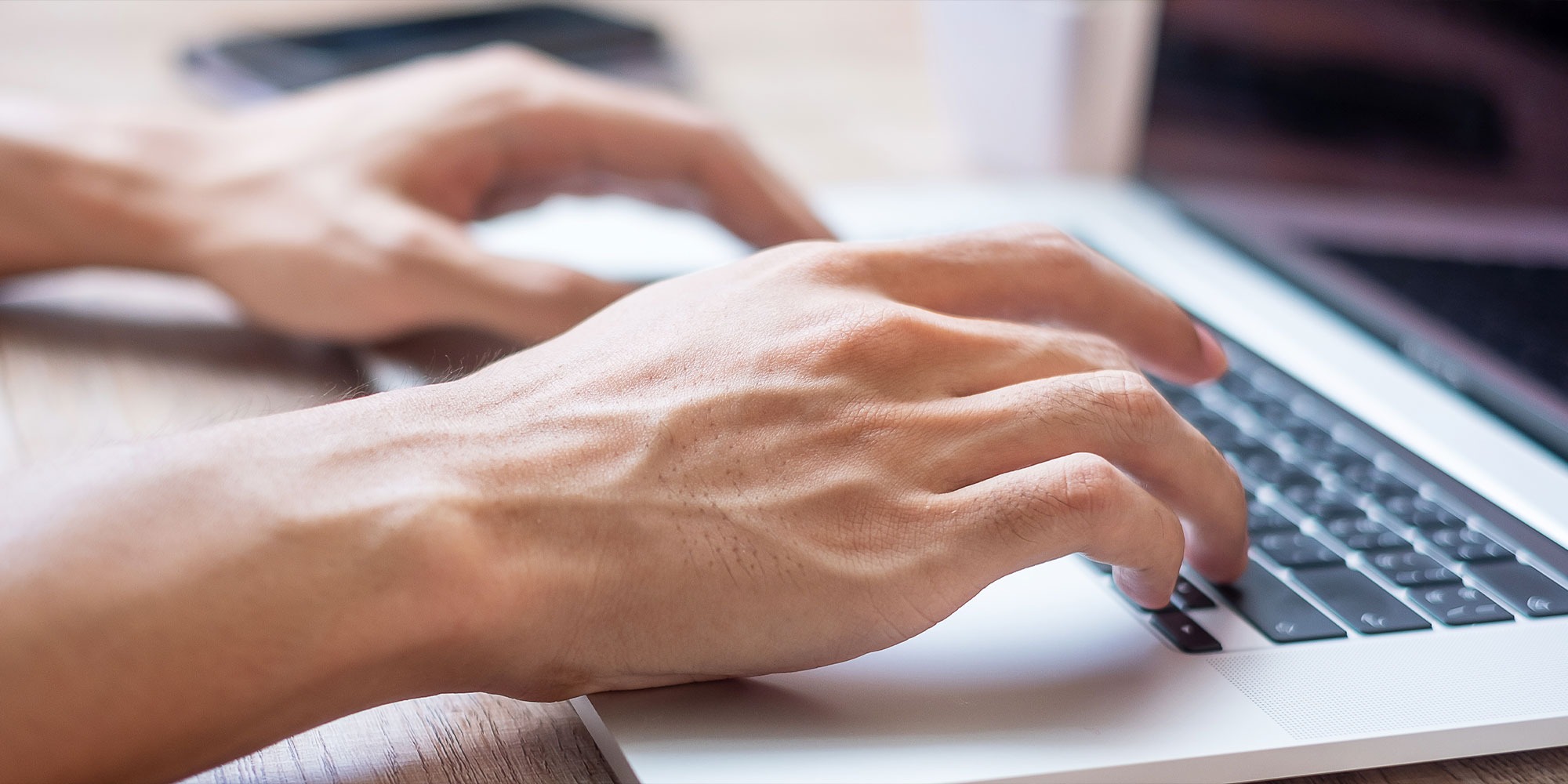 Guy typing on laptop writing a blog post
